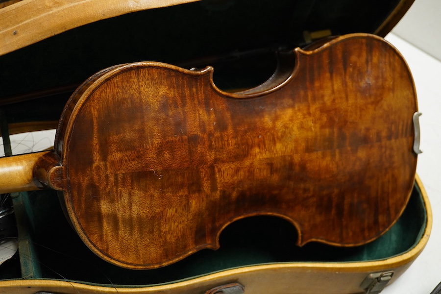 Four cased violins; an early 20th century violin, body 36cm, fitted with a microphone pick up taking a quarter inch jack plug, an early 20th century half size violin, body 32cm, and two student violins. Condition - poor